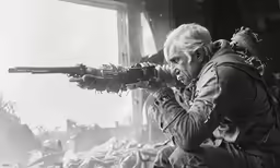 black and white photograph of a man aiming a gun