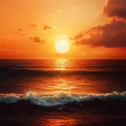a sunset over the ocean with waves crashing