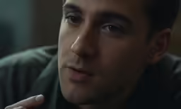 a young man looks into the distance while staring away