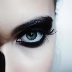 an extreme shot of a woman with the makeup applied up