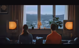 two people watching television in the living room