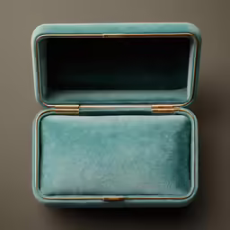 two green velvet boxes one with gold trim and the other green
