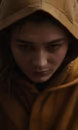 a young person with long hair and a large brown hoodie