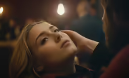 the woman is getting her makeup done