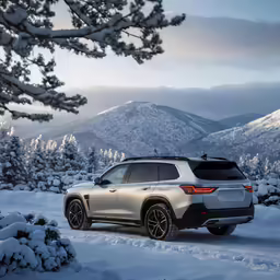 a picture of the side of a white suv in the snow