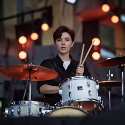 a girl with drums and the drumstick