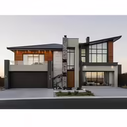 a large modern house with a brick driveway and car garage