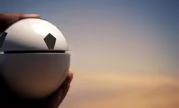 an object is in the palm of hand against a blue sky
