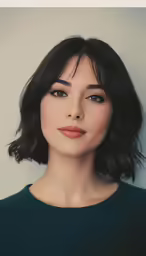 an attractive asian woman with dark hair and makeup looking at the camera