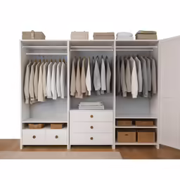 clothes hanging on the rack next to a white drawer