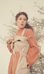 a girl is standing with her hands on her hips
