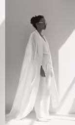 a woman with glasses and a dress in white