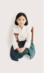 an asian girl sits on a chair with a cane in one hand and in the other