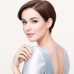 a beautiful woman with short hair poses for a photo