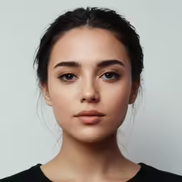 a young woman with the cheekbones, dark hair and smoky blue eyeshadow