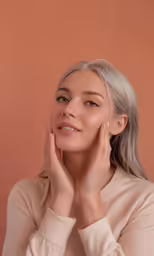 woman with a gray hair wearing pink shirt looking ahead
