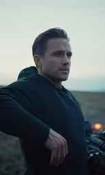 a man standing in front of some motor bikes