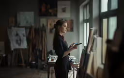 a woman standing in a room holding a tablet