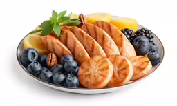 a plate filled with cut fruit and nuts