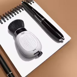 a pen and other items on a spiral notebook