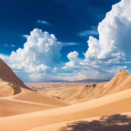a sandy area surrounded by clouds and sand dunes