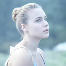 the girl is wearing blue, and is staring at something