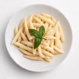 the food on the plate includes fries, cheese and herbs