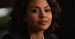 an african american woman wearing a black suit and a necklace