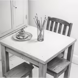 a simple dining table and chairs are in a room