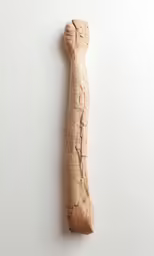 a wood stick, with an odd shaped top piece