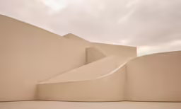 the wall is made out of cement with a curved roof