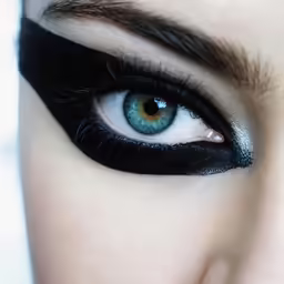 an eye with a blue eyeliner and black eyelashes