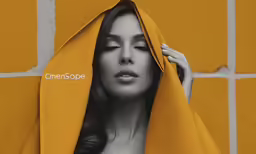 a woman with long hair in yellow hoodie