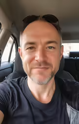 a man with sun glasses in the car