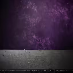 purple sky above a concrete wall with a black bottom