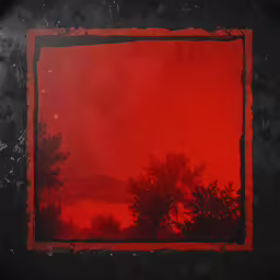 a red sky behind trees near a body of water