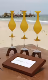 three glasses sitting on a table in front of an open frame