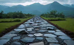 a stone path leading away from mountains