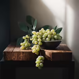 white grapes sit in a bowl near a wooden table