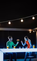 man and woman talking to each other at a table