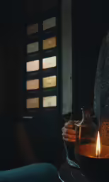 a candle with a bottle in it sitting on a table