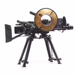 a wooden camera on a tripod with its legs extended and the lens resting on the top of it
