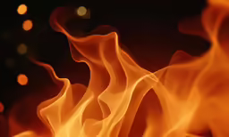 a close up view of bright flames on a black background