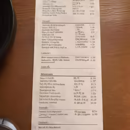 a menu from a restaurant sits next to some cups