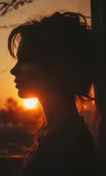 woman staring out from behind an umbrella at sunset