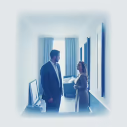 two people in a living room talking next to each other