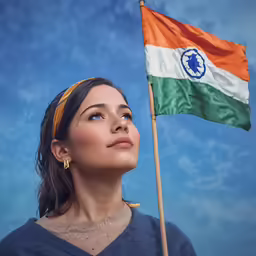 an indian woman holding the indian flag