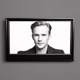a black and white photo of a man with a suit on