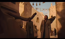the man is standing next to the statue