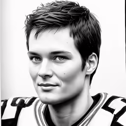 a young man in football jersey posing for the camera